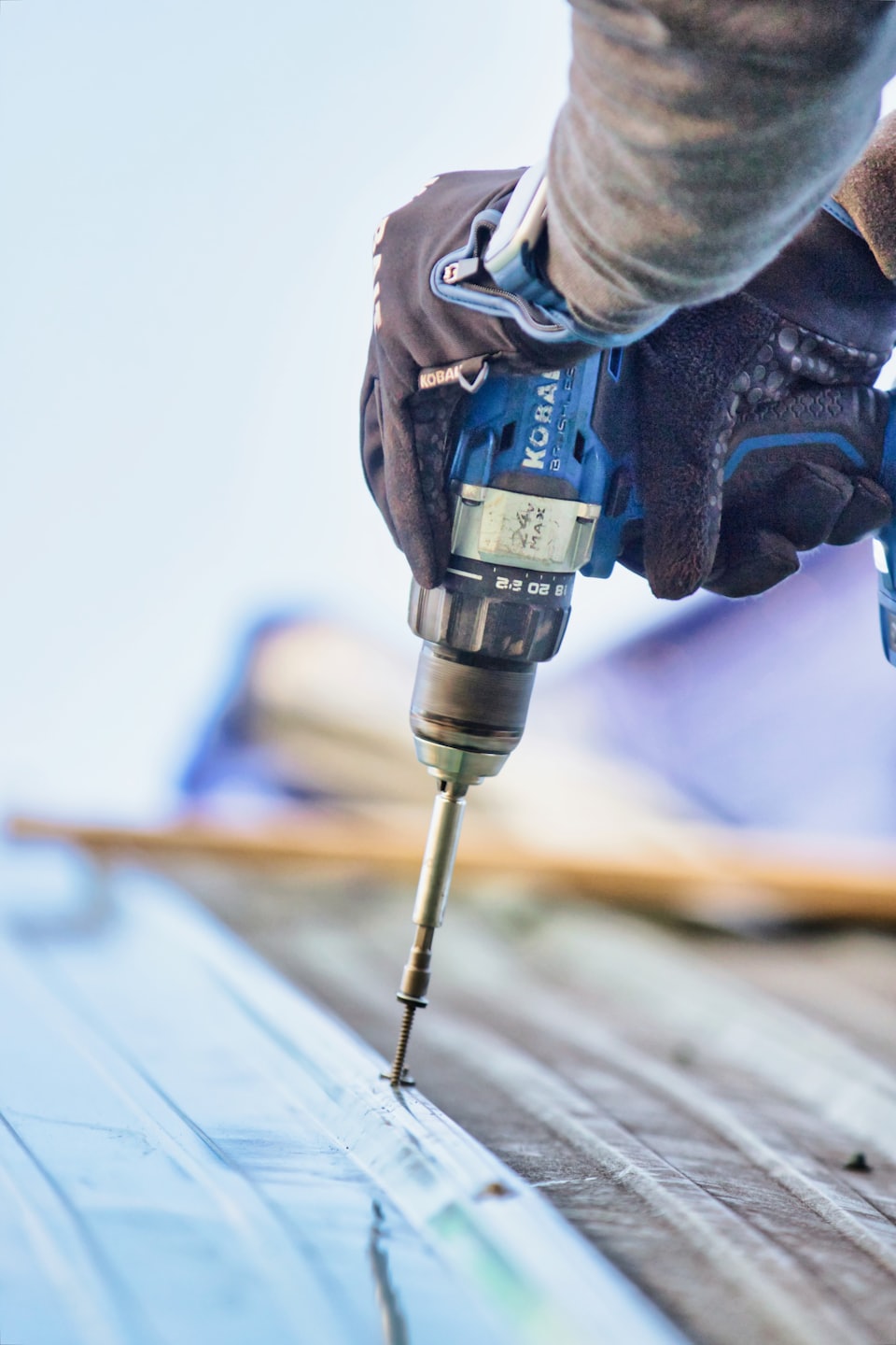 Metal roofing being installed by a worker