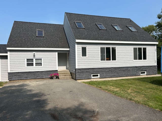 new stone on the bottom part of a house under the siding